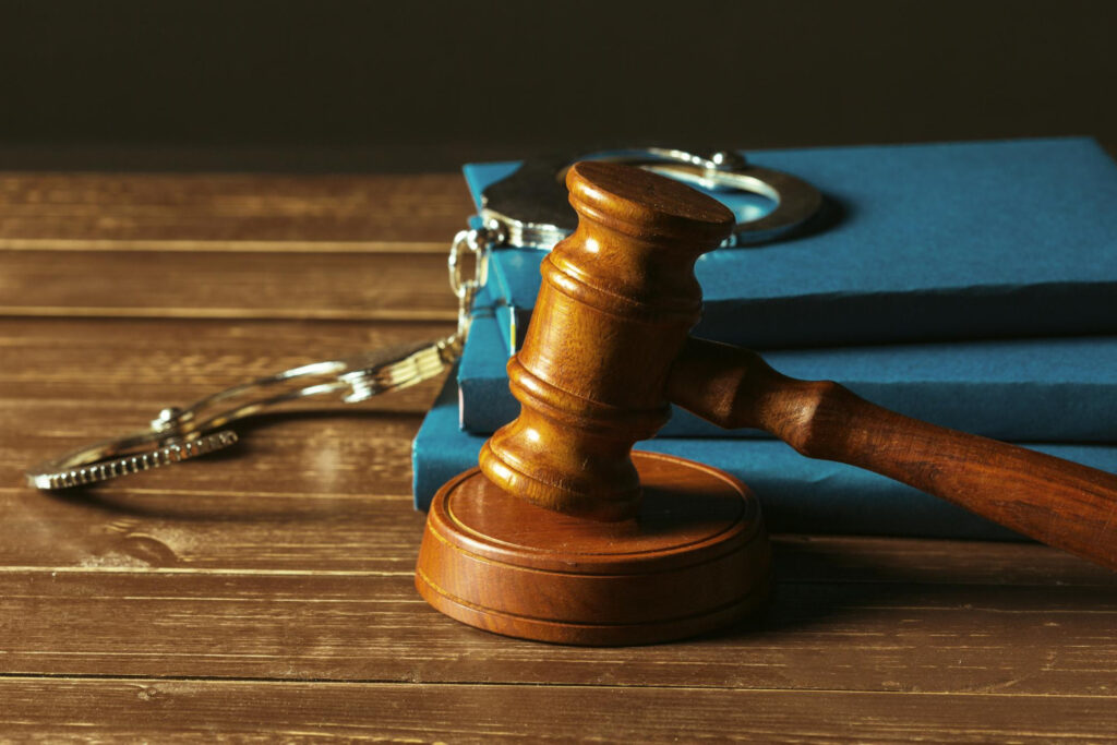 Gavel With Books On Old Wooden Desk