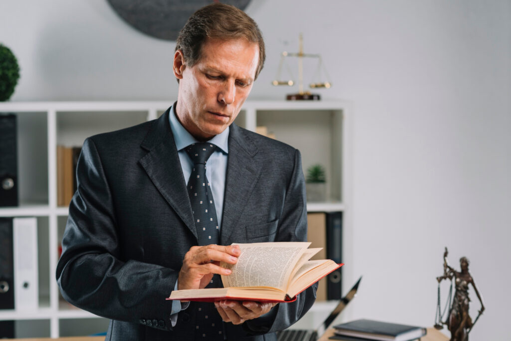 Lawyer turning pages of law book