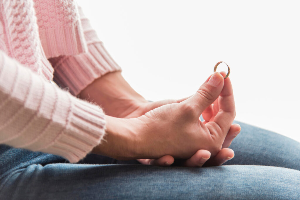 Woman holding golden wedding ring