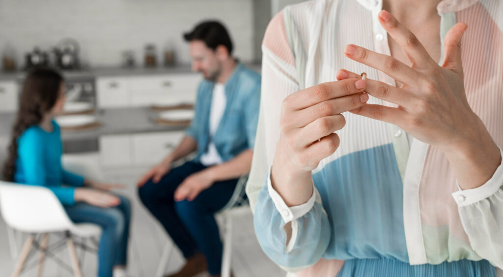 Woman taking wedding ring off