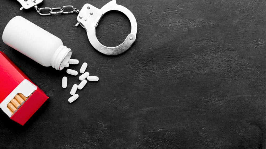 Handcuffs with pills and cigarettes