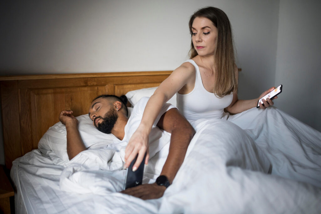 Woman checking her boyfriend's phone