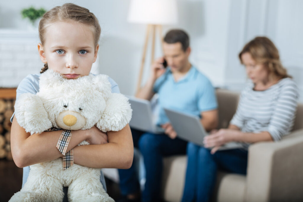 Girl standing and holding her toy