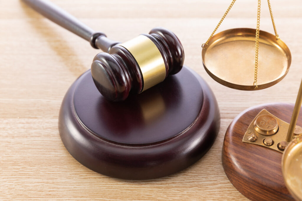 gavel and a scale on a wooden surface