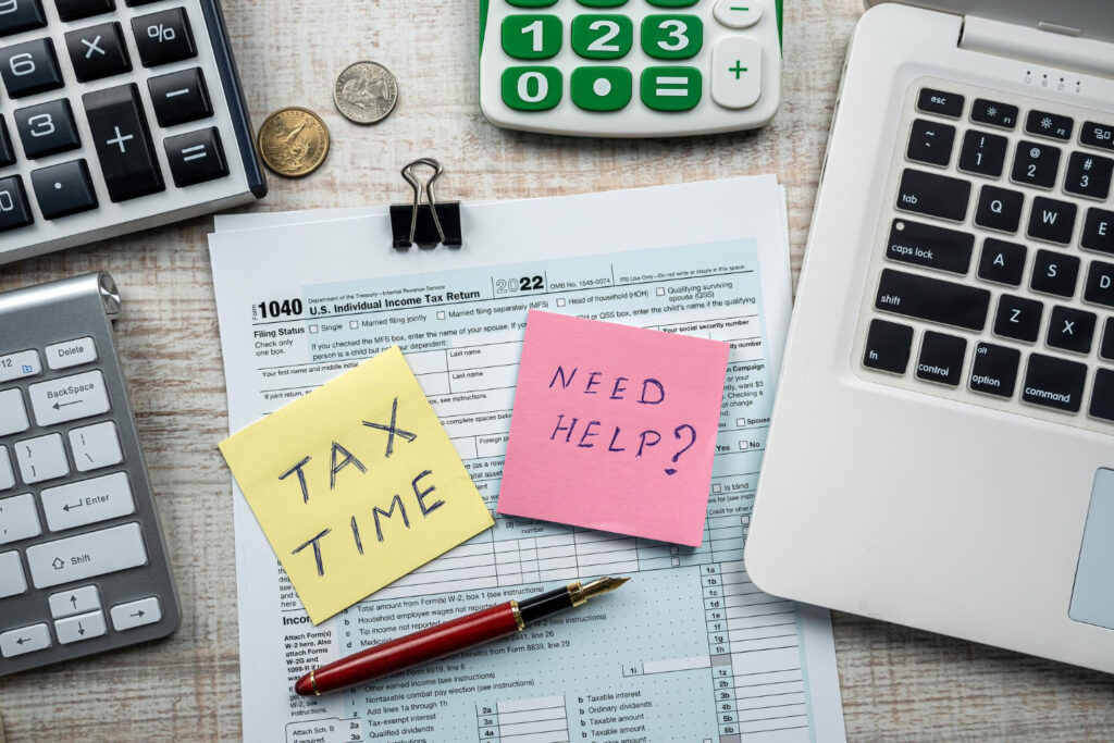 Tax forms with pen and computer keyboard